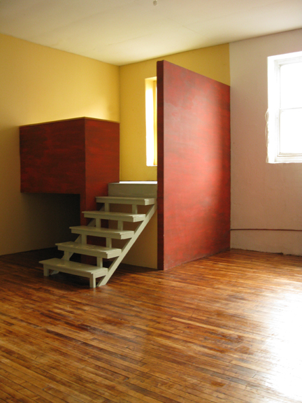 Photograph of a space that can function either as a sleeping loft or an office