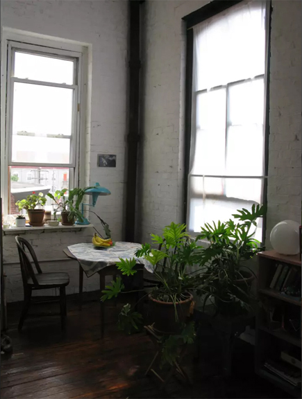 table and chair with South and West windows in 3F